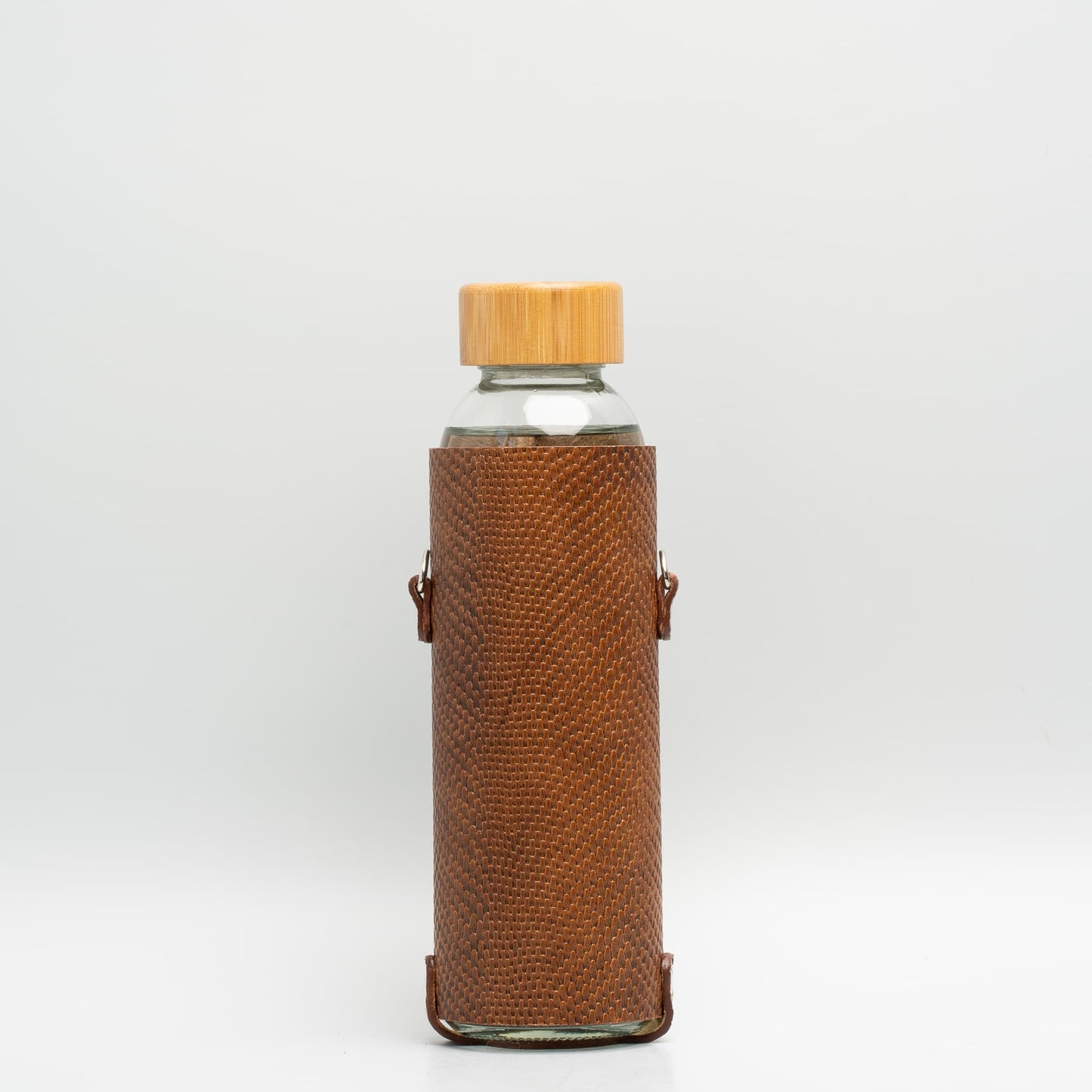 Leather water bottle holder with strap and glass bottle